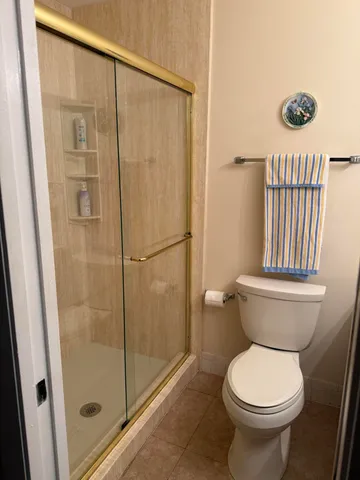 a bathroom with a toilet and a shower