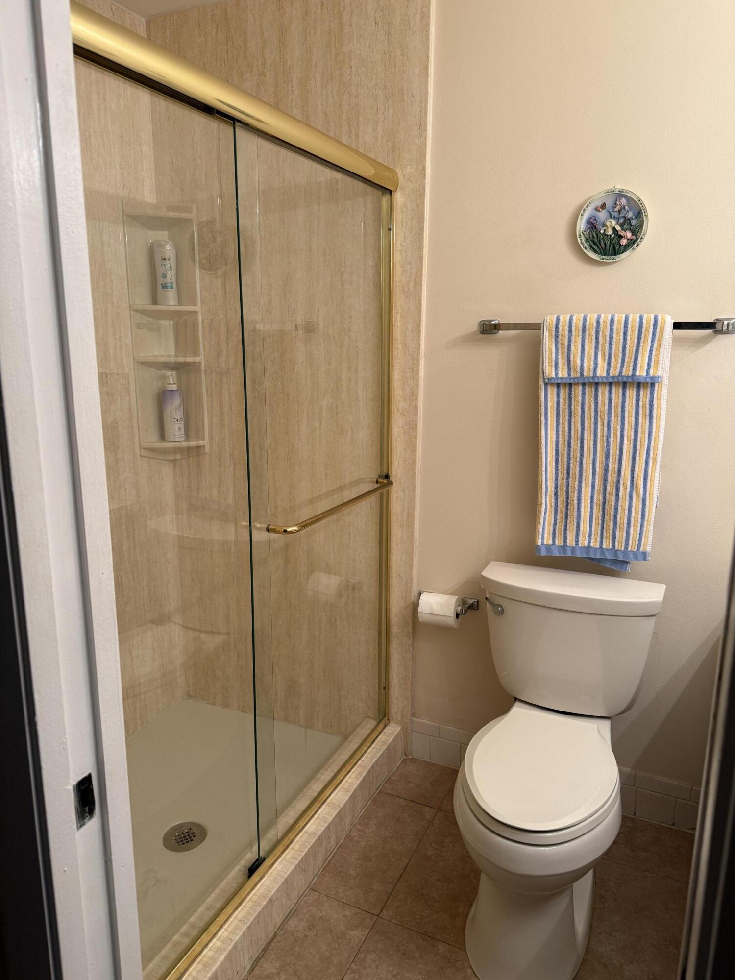 4515 Northwest 3rd Street, Unit A Delray Beach, FL 33445 - Photo 27 of 28 a bathroom with a toilet and a shower