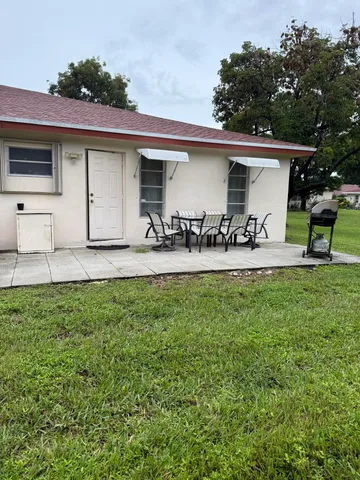 a front view of house with yard and seating area