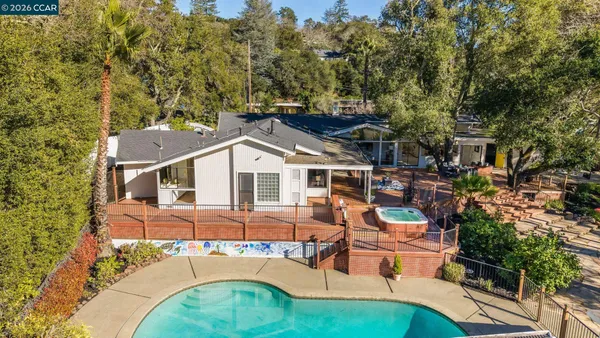 an aerial view of a house with a yard table and chairs
