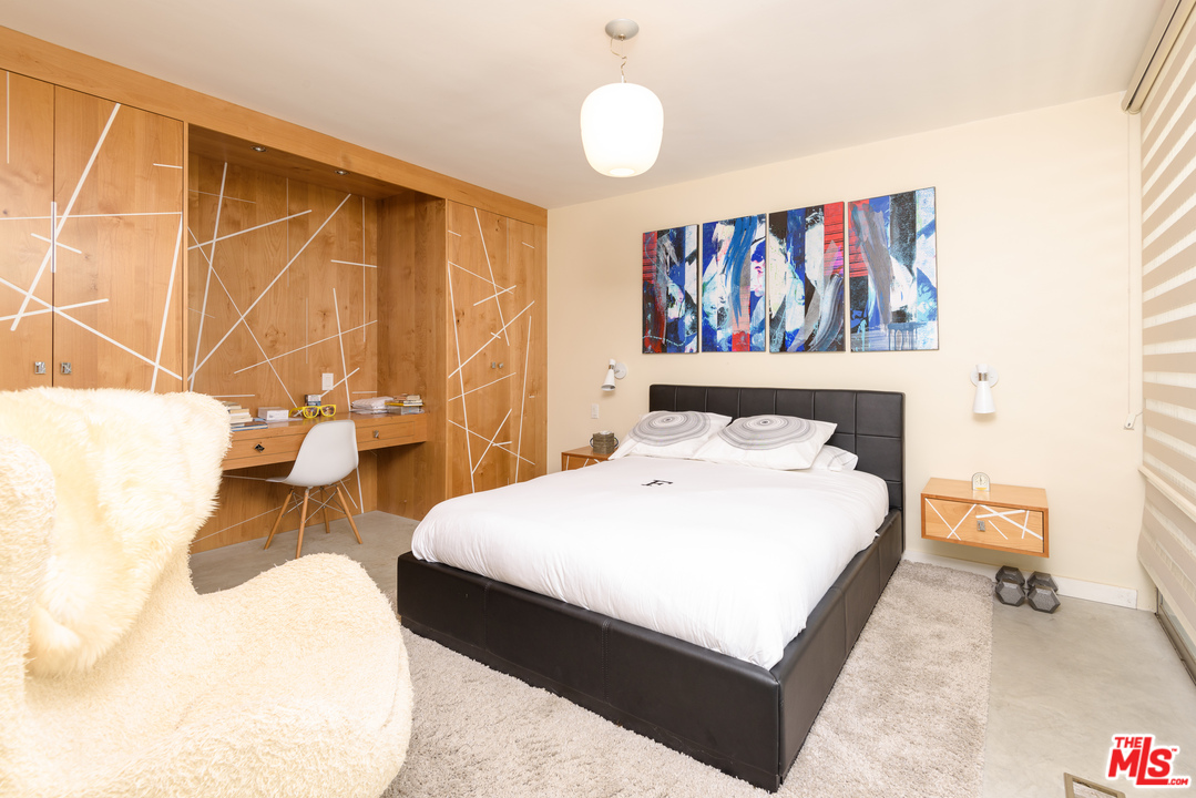 871 Leonard Road Los Angeles, CA 90049 - Photo 19 of 28 a bedroom with a bed and wooden floor