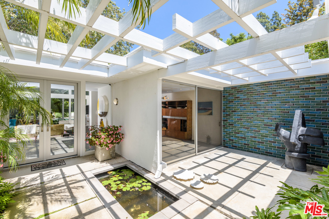 871 Leonard Road Los Angeles, CA 90049 - Photo 2 of 28 a view of an entryway with a flower pot