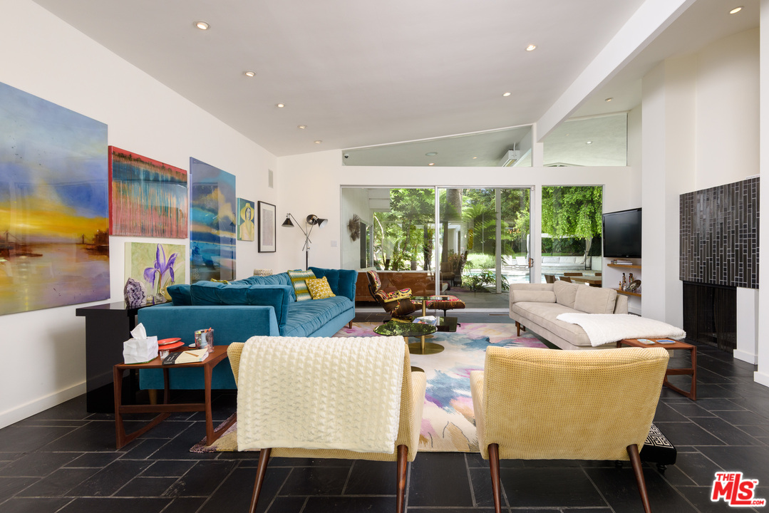 871 Leonard Road Los Angeles, CA 90049 - Photo 6 of 28 a living room with fireplace furniture and a large window