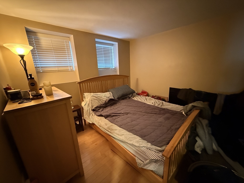 20 Chapel Street, Unit C308 Brookline, MA 02446 - Photo 8 of 15 a bed sitting in a bedroom next to a window