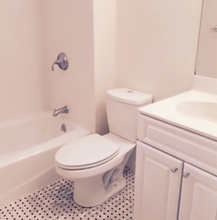 20 Chapel Street, Unit C308 Brookline, MA 02446 - Photo 10 of 15 a white toilet sitting next to a bath tub