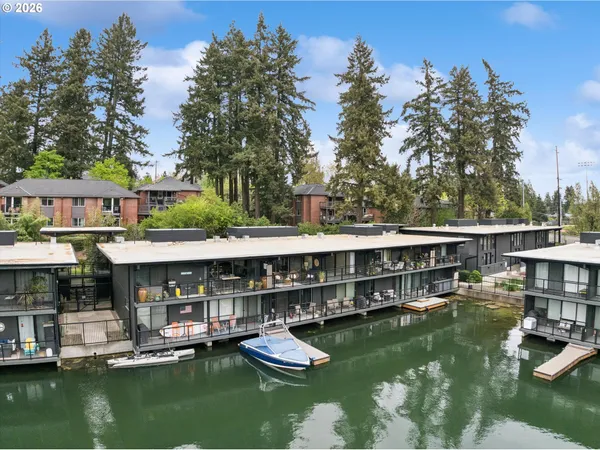 a view of an ocean with boats and trees in the background