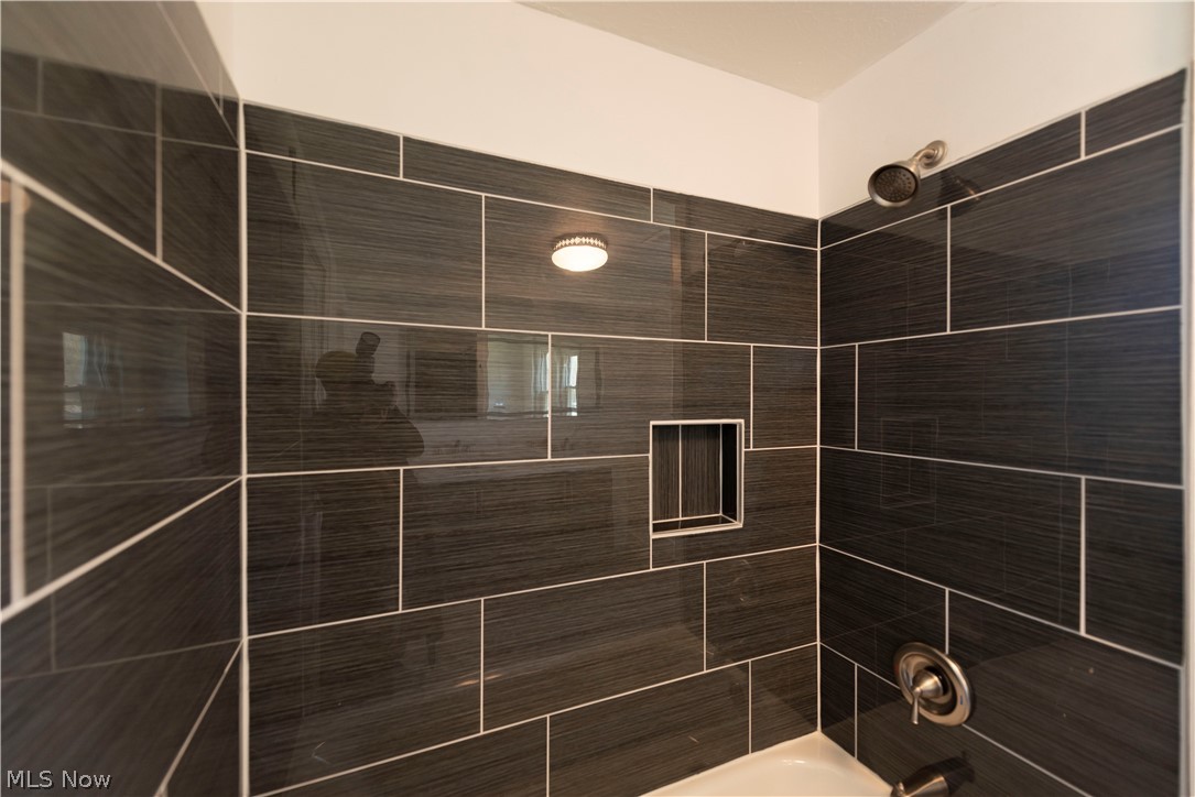 1022 North Howard Street Akron, OH 44310 - Photo 13 of 38 Second floor bathroom's fabulous tile surround with nook and brushed nickel fixtures.