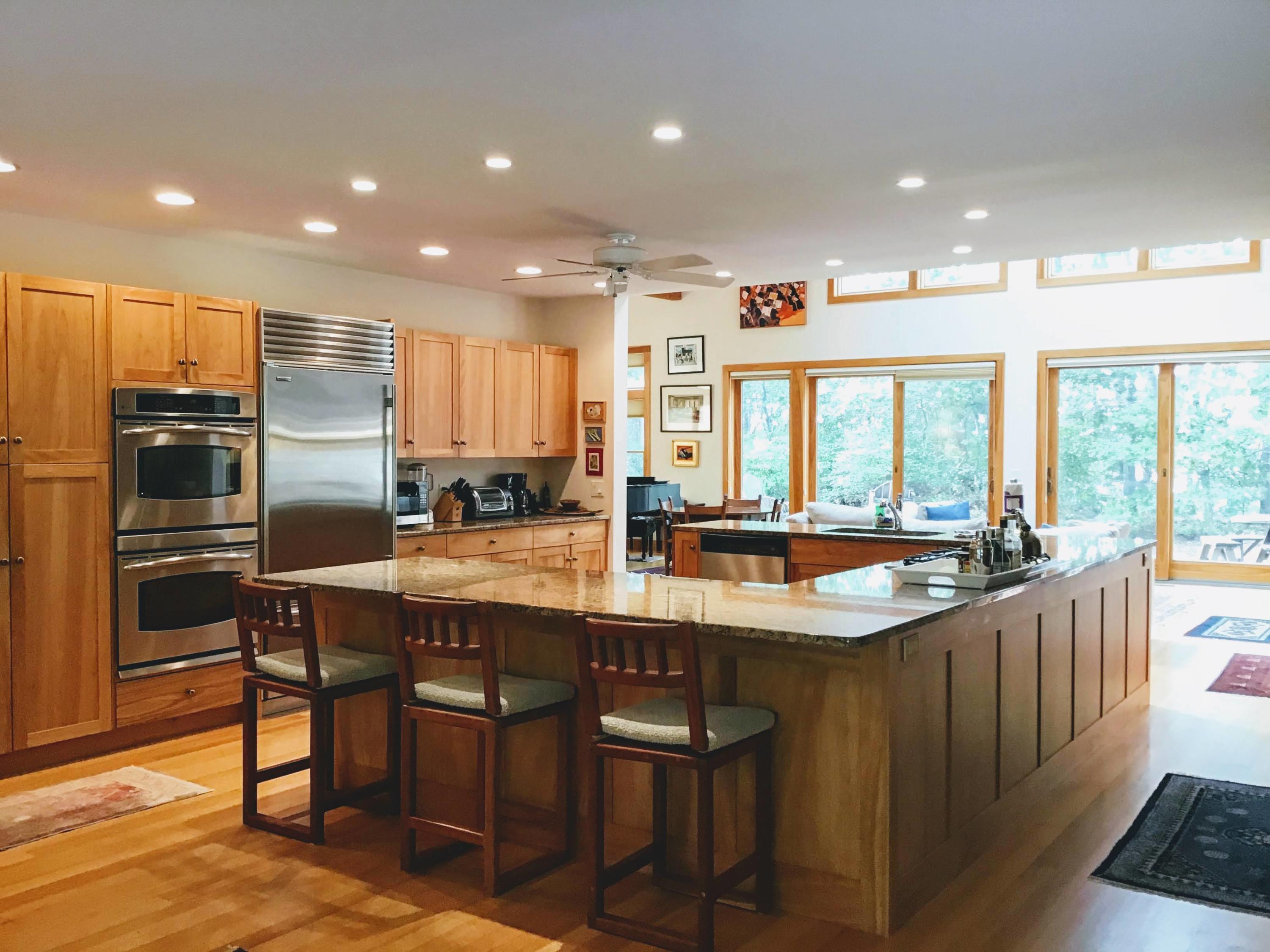 150 Tonset Road Orleans, MA 02653 - Photo 18 of 54 a kitchen with stainless steel appliances granite countertop a sink and a refrigerator