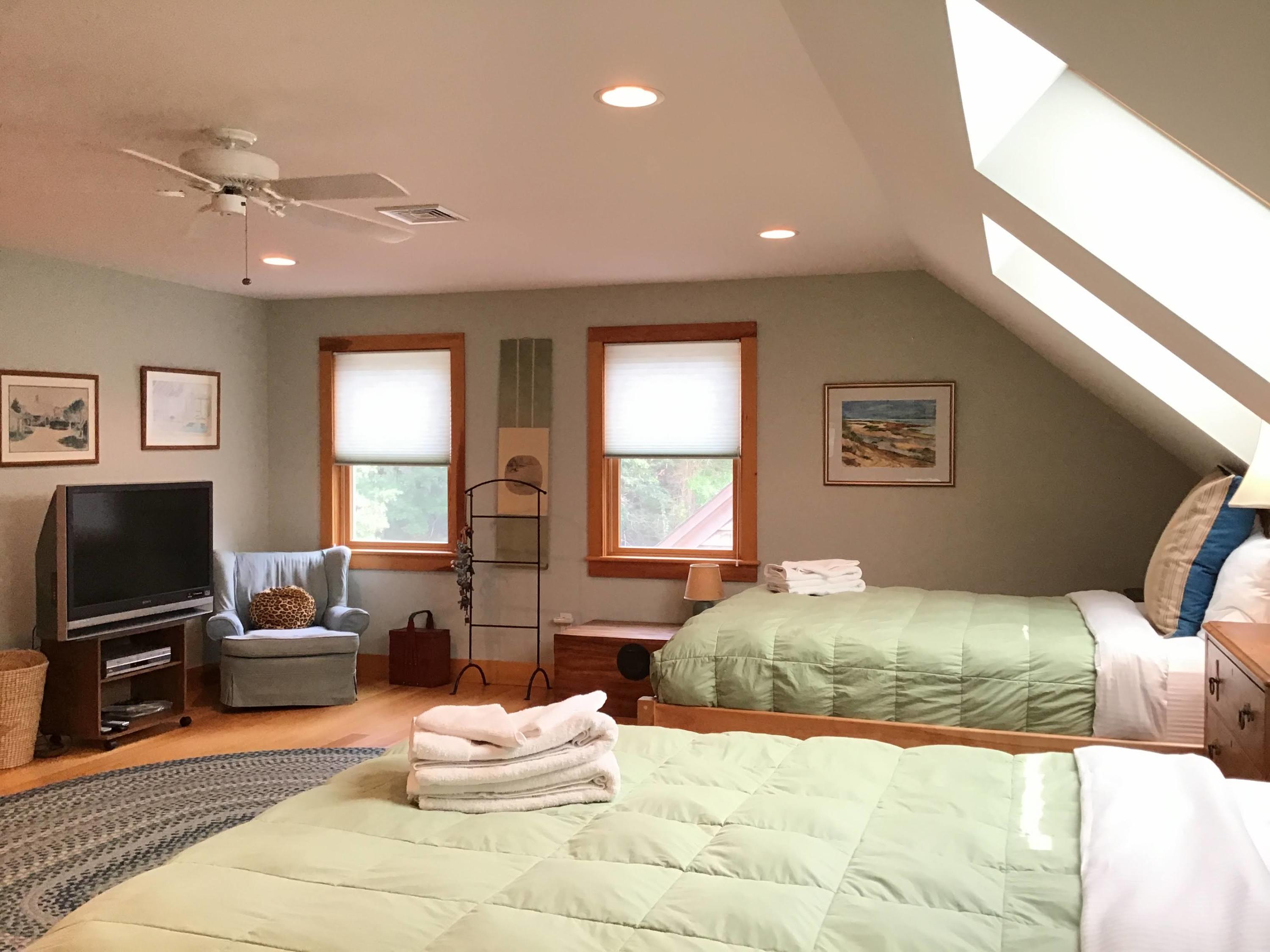 150 Tonset Road Orleans, MA 02653 - Photo 44 of 54 a bedroom with a bed and glass windows