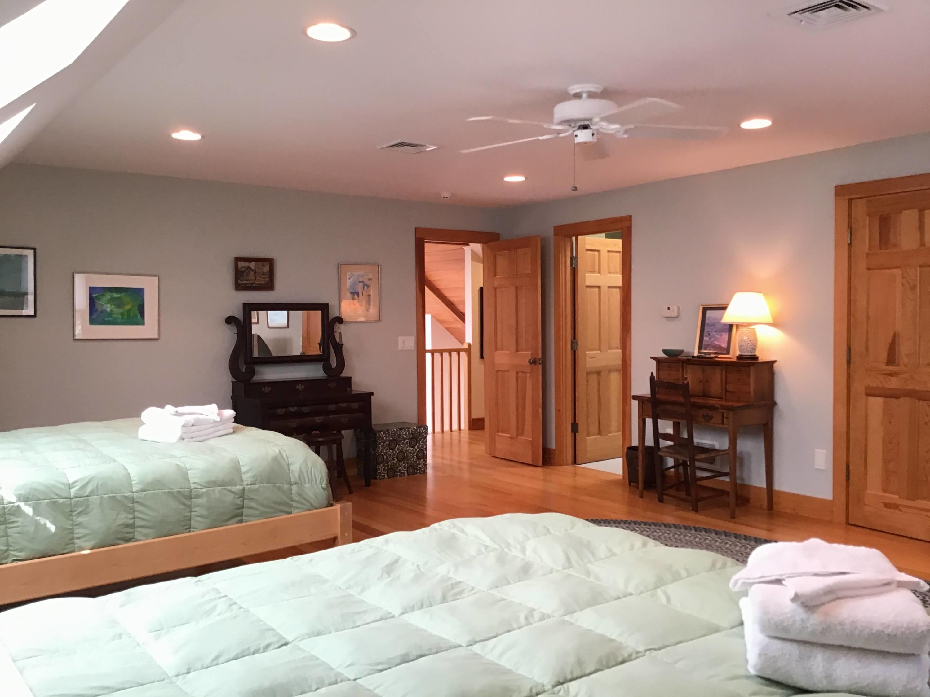 150 Tonset Road Orleans, MA 02653 - Photo 46 of 54 a bedroom with a bed and wooden floor