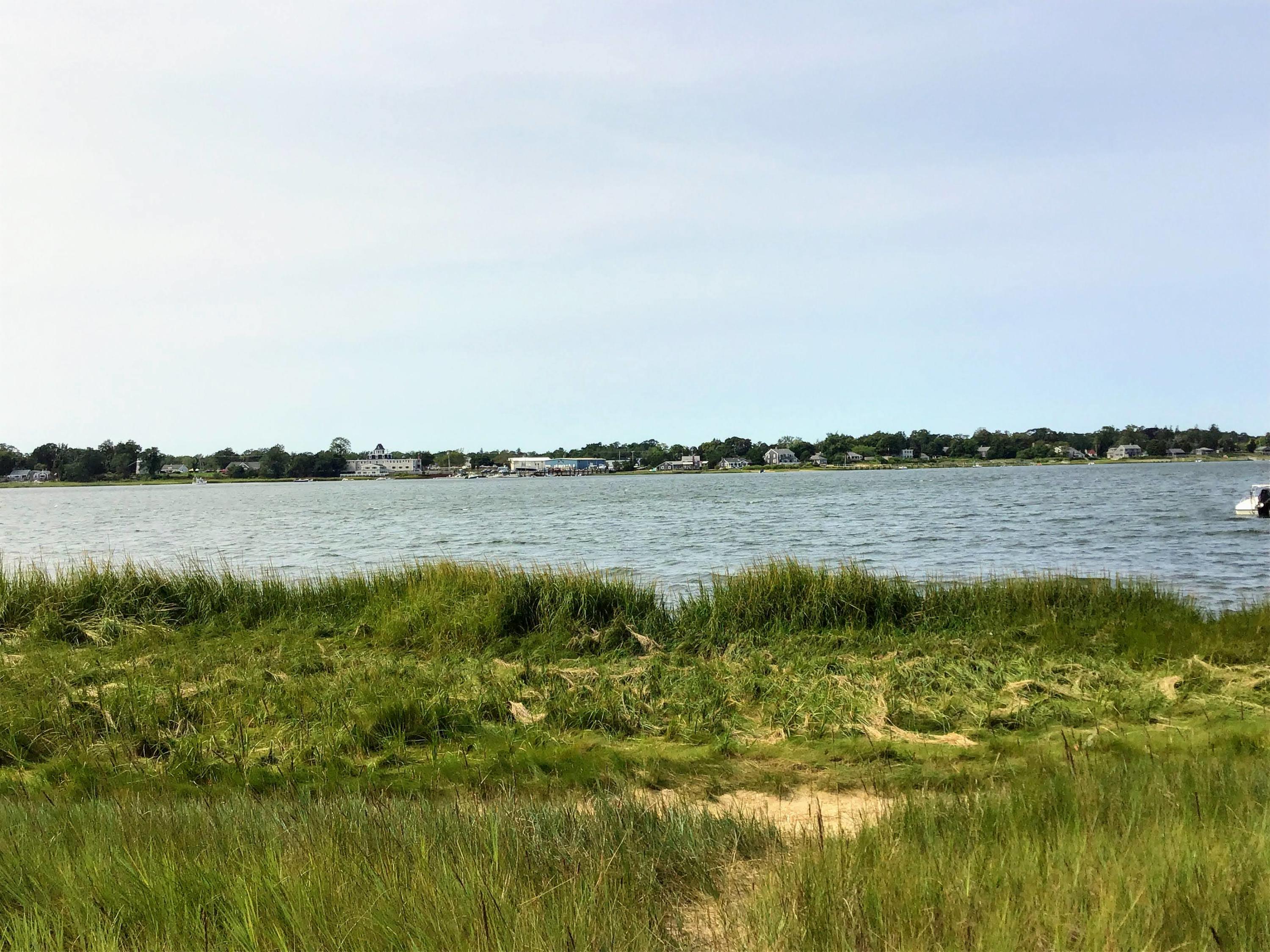 150 Tonset Road Orleans, MA 02653 - Photo 7 of 54 a view of a lake with houses in the back
