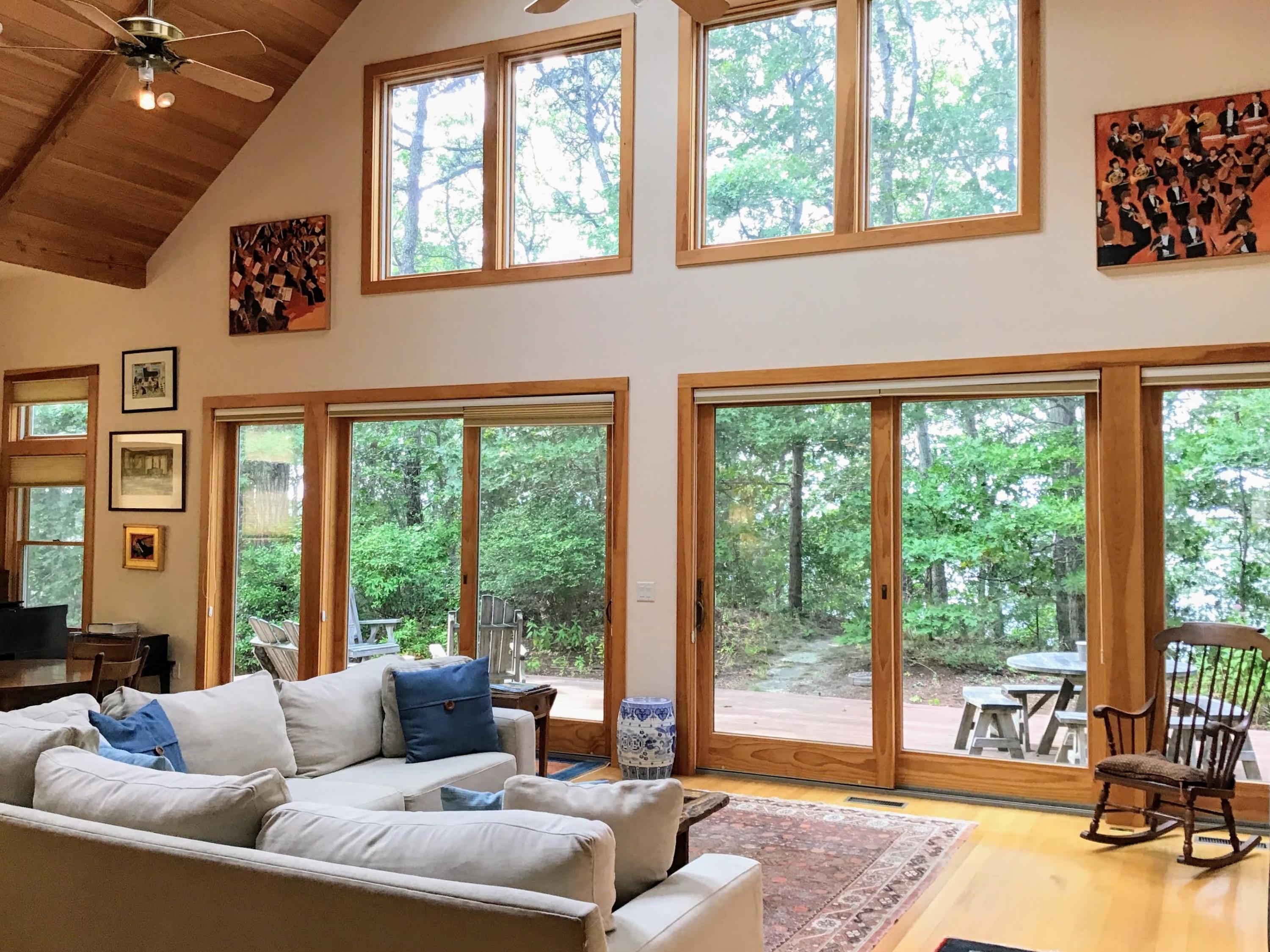 150 Tonset Road Orleans, MA 02653 - Photo 10 of 54 a living room with furniture and large windows