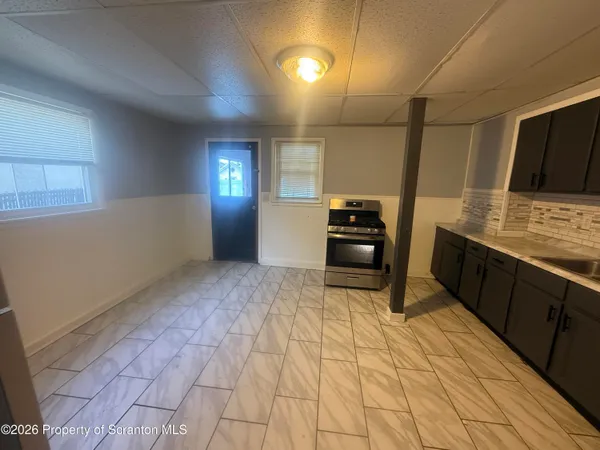 a kitchen with stainless steel appliances a refrigerator and cabinets