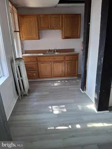 a kitchen with a sink a stove and cabinets