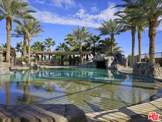 a view of a swimming pool with a patio and a lake view