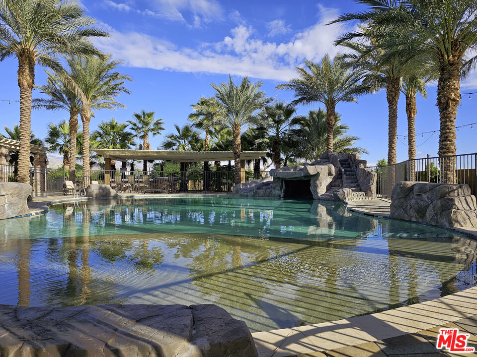 38580 Rancho Los Cerritos Drive, Unit S1 Indio, CA 92203 - Photo 12 of 39 a view of a swimming pool with a patio and a lake view
