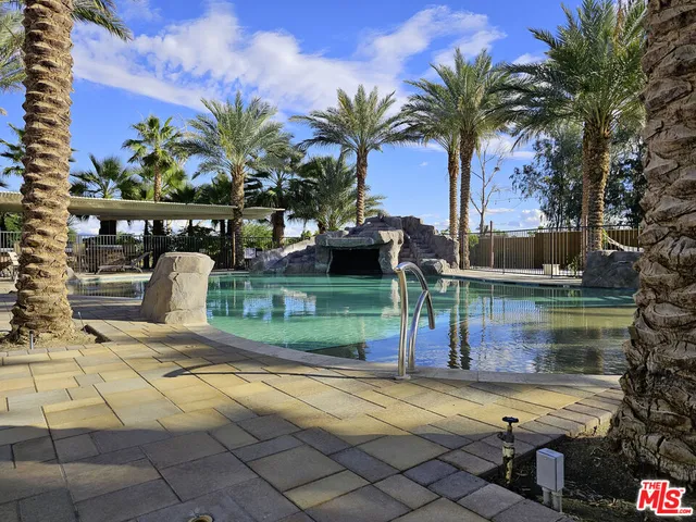 a view of a patio with table and chairs potted plants and palm tree