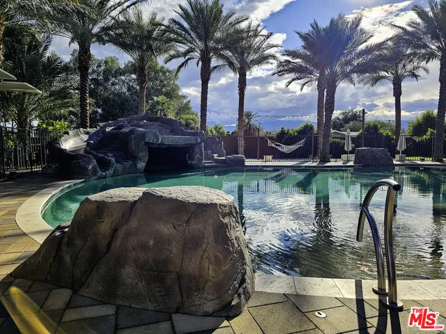 a swimming pool with outdoor seating and yard