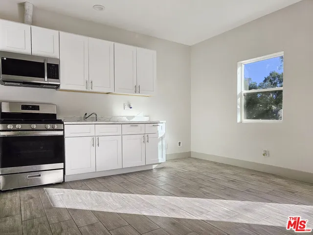 a view of a kitchen with electric appliances