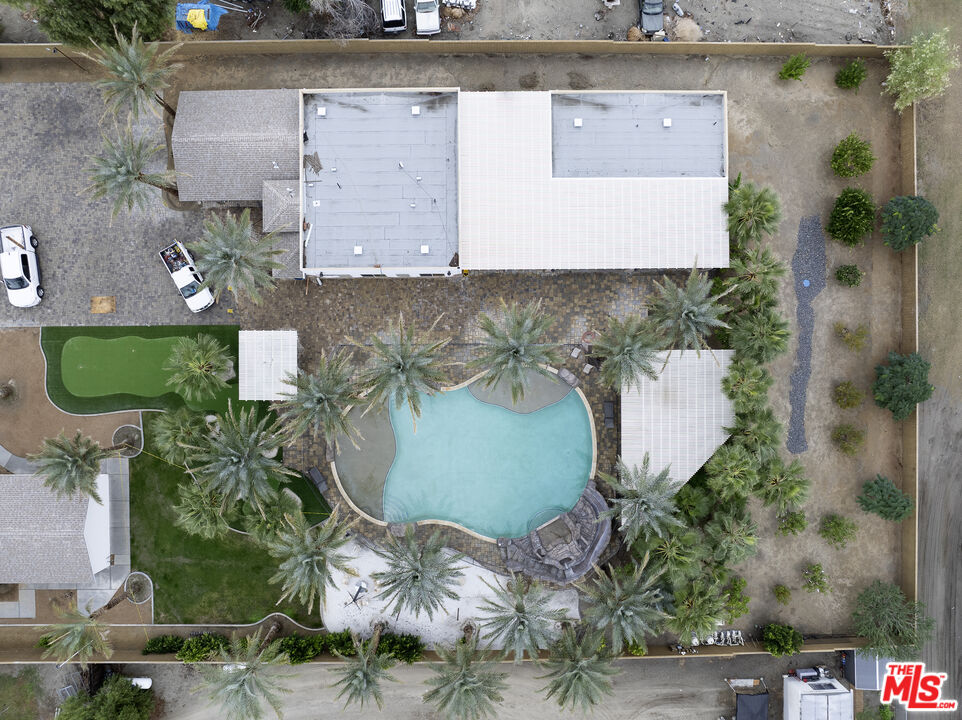38580 Rancho Los Cerritos Drive, Unit S1 Indio, CA 92203 - Photo 35 of 39 an aerial view of a house with a yard and a fountain