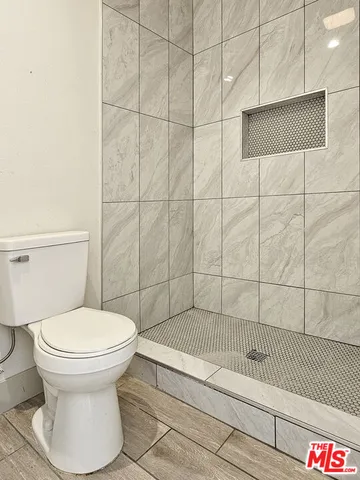 a bathroom with a toilet and a shower