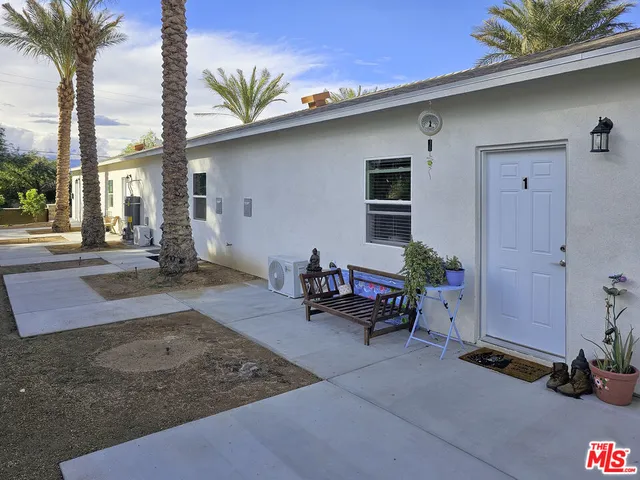 a backyard of a house with table and chairs