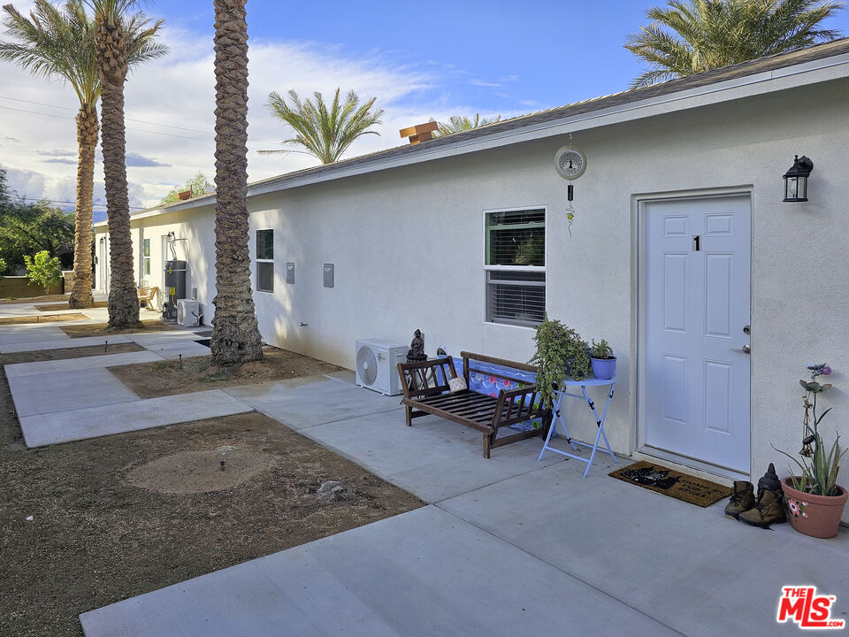38580 Rancho Los Cerritos Drive, Unit S1 Indio, CA 92203 - Photo 8 of 39 a backyard of a house with table and chairs