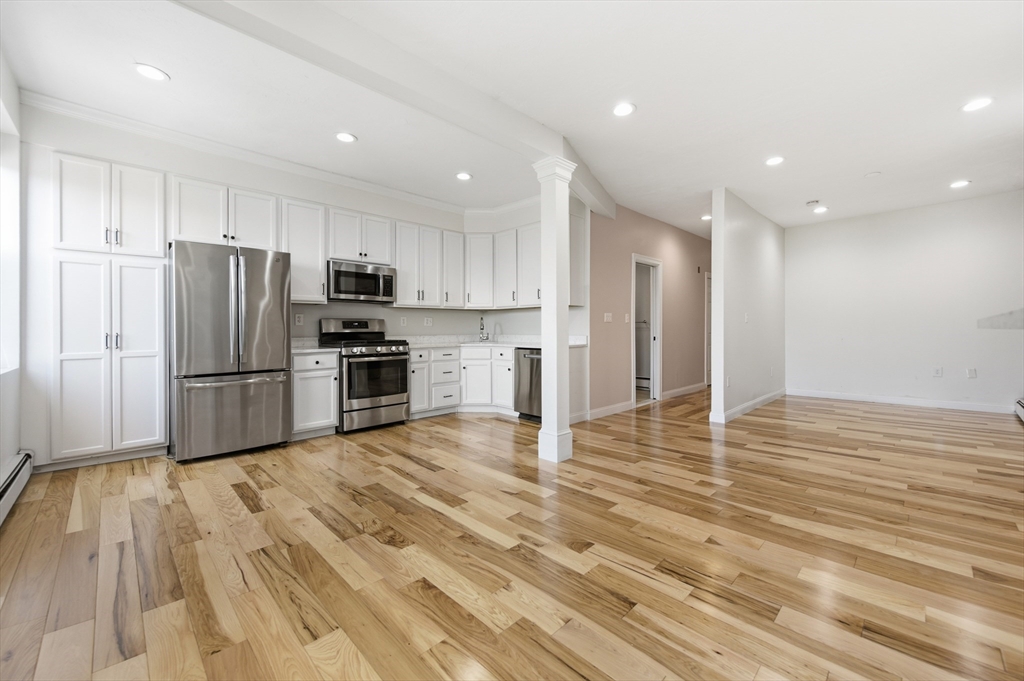 a kitchen with stainless steel appliances a refrigerator and a stove top oven