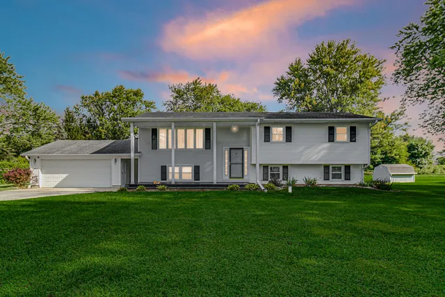 a front view of house with yard and green space
