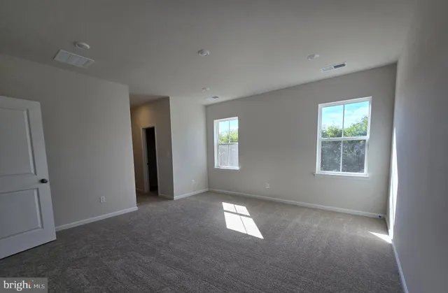a spacious bathroom with a granite countertop sink and a mirror