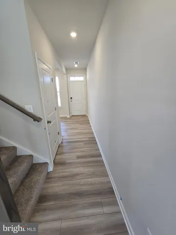 a view of entryway and hall with wooden floor