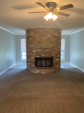 a view of empty room with window and fireplace