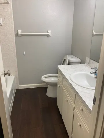 a bathroom with a sink a toilet and a mirror