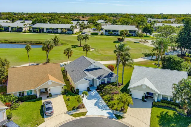 an aerial view of a house with a garden lake view