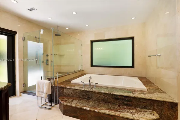a bathroom with a bathtub and a shower