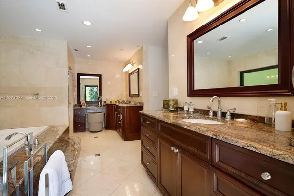a spacious bathroom with a granite countertop sink mirror and double