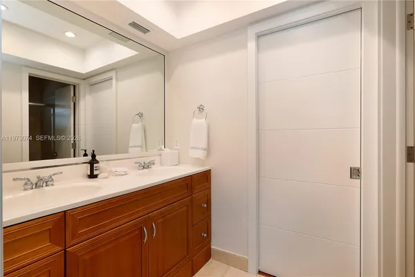 a bathroom with a double vanity sink and a mirror