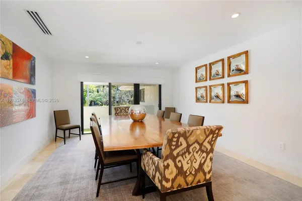a dining room with furniture and window
