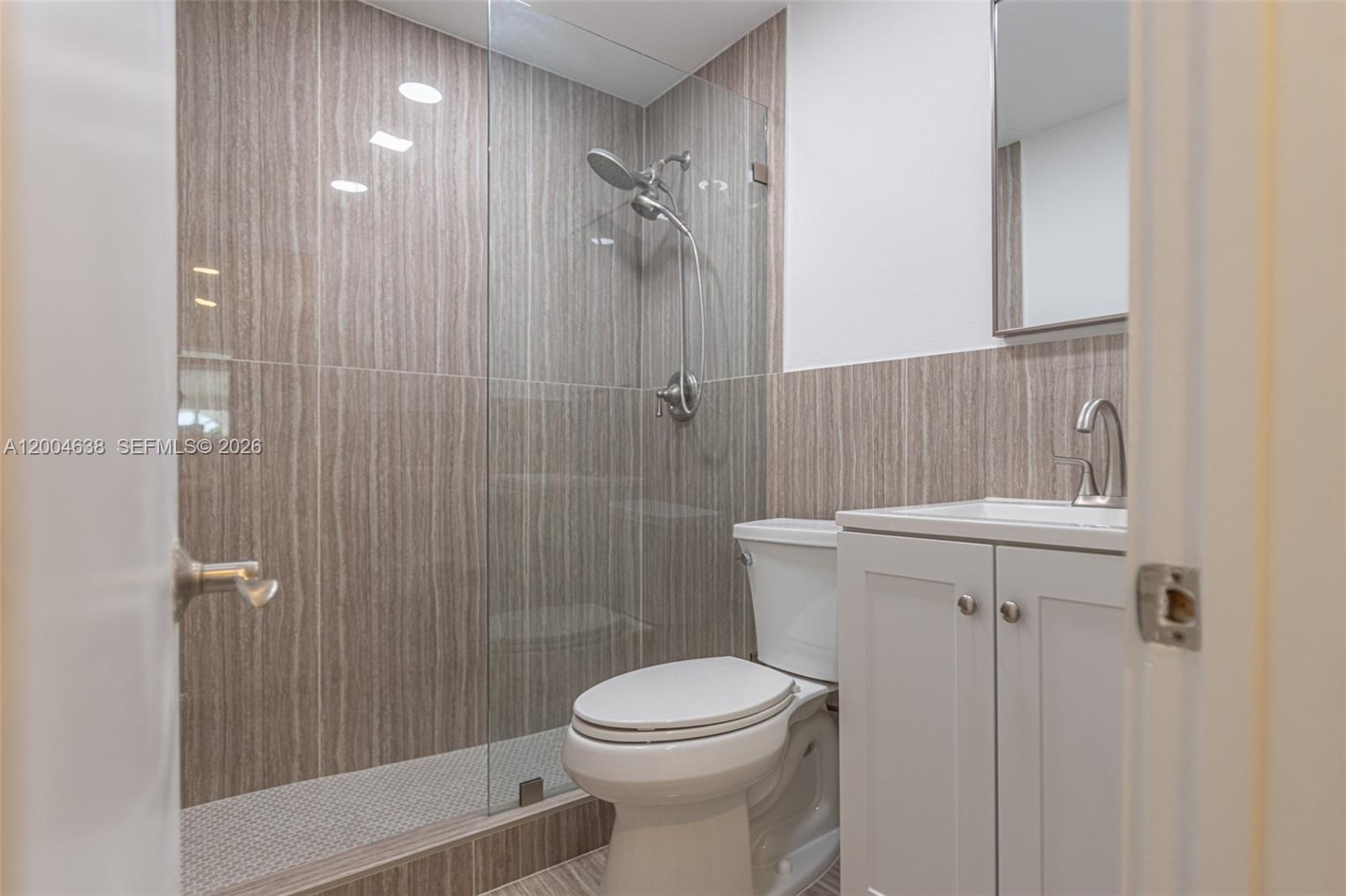 1690 Daytonia Road Miami Beach, FL 33141 - Photo 82 of 88 a bathroom with a toilet a sink and shower