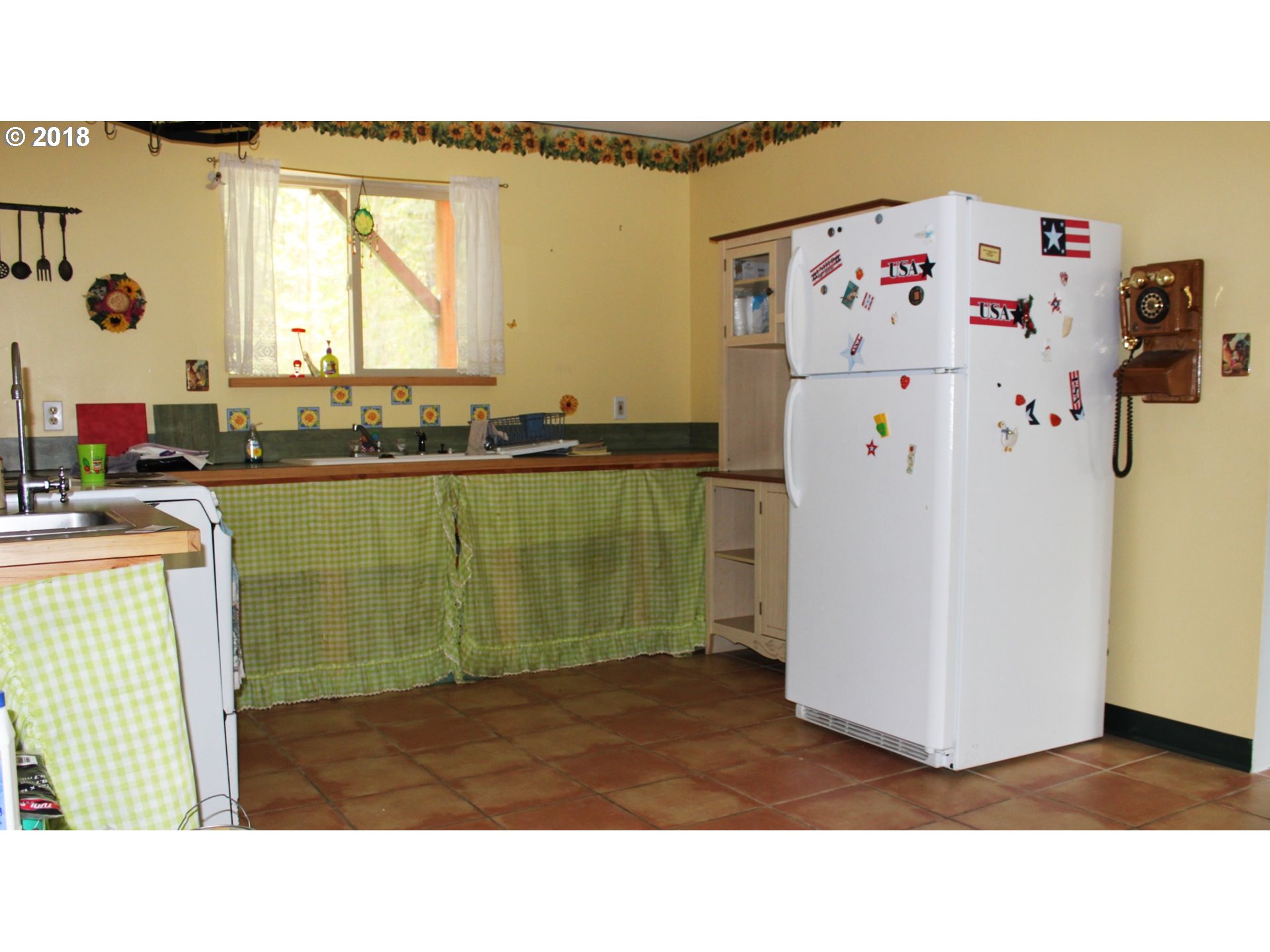 1075 Maple Sumpter, OR 97877 - Photo 3 of 8 a kitchen with a refrigerator and a sink
