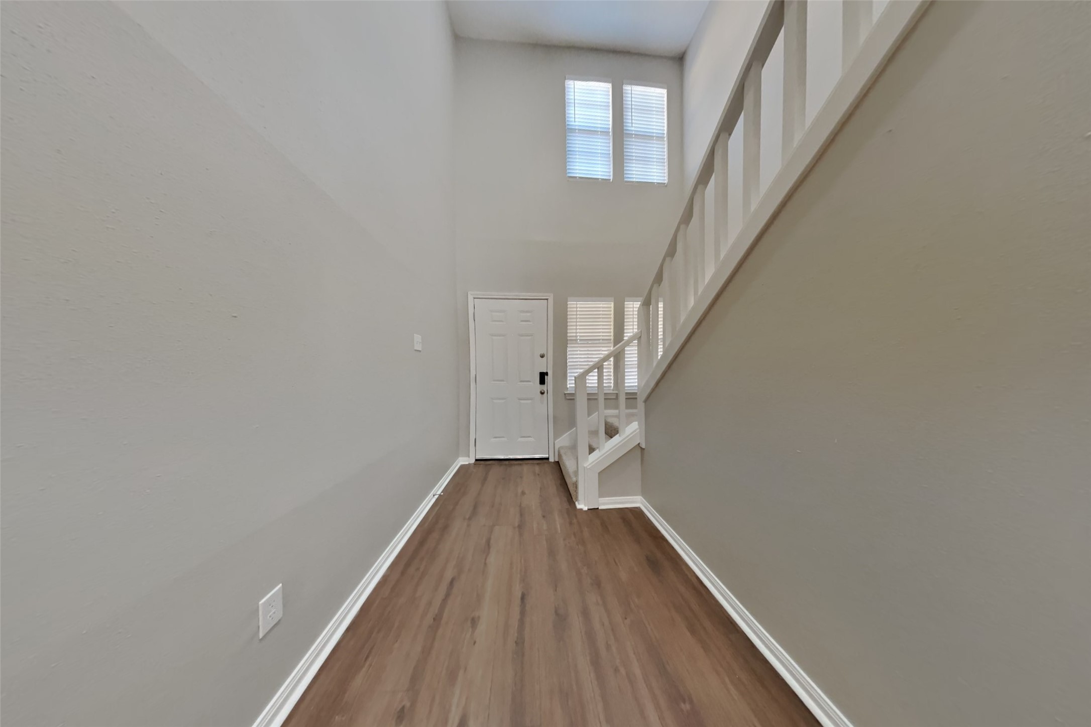 3423 Berry Grove Drive Spring, TX 77388 - Photo 2 of 21 a view of a hallway with wooden floor and staircase