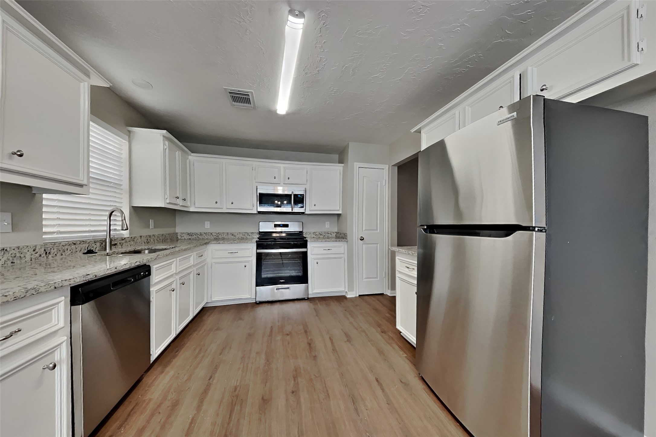 3423 Berry Grove Drive Spring, TX 77388 - Photo 9 of 21 a kitchen with a refrigerator a sink and dishwasher