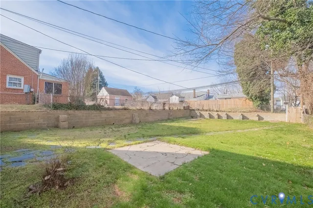 a view of a house with a wooden fence