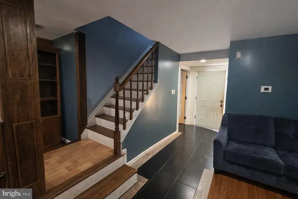 a view of entryway and hall with wooden floor