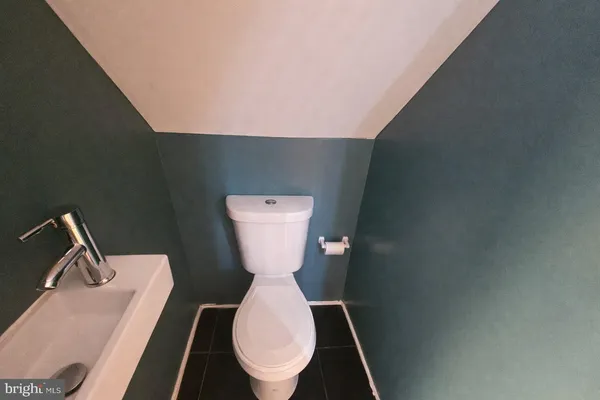 a toilet sitting in a bathroom next to a sink