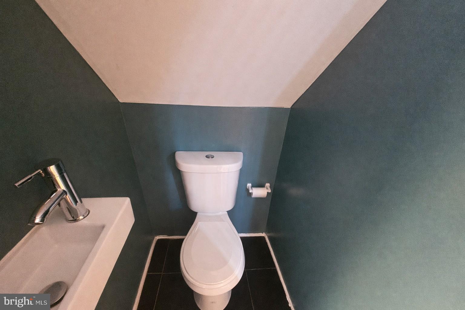 1315 Honan Street Chester, PA 19013 - Photo 9 of 15 a toilet sitting in a bathroom next to a sink