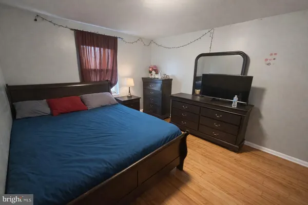 a bedroom with a bed and a dresser