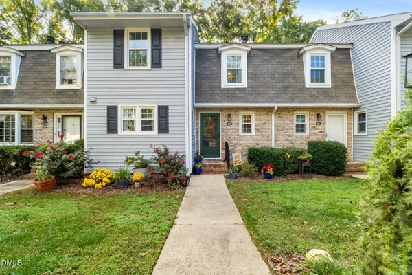 a front view of a house with garden and porch