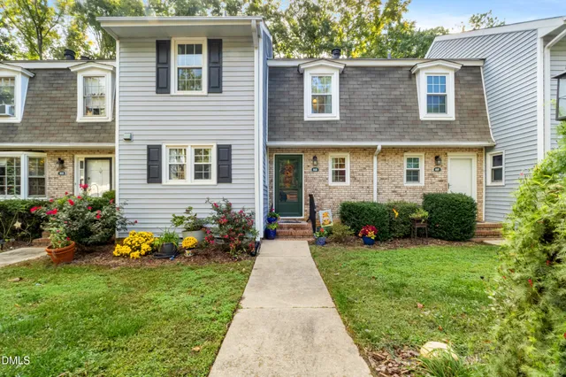 a front view of a house with garden and porch