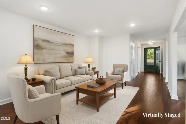 a living room with furniture and a painting on the wall